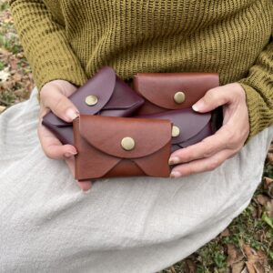 four leather pouches, brass snap and full grain leather.