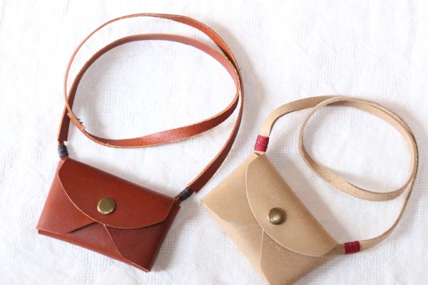 kid's leather pouch purse in chestnut and tan.